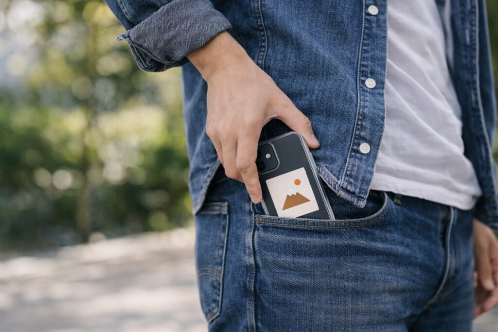 外出先でスマホをポケットに入れる男性の後ろ姿 or 手元 清潔感・落ち着いた雰囲気